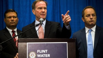 Six more Michigan state workers face charges over Flint water crisis