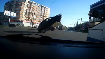 Video catches car flipped over by downed power cables