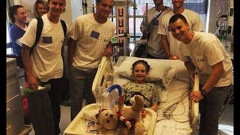 Fraternity brothers surprise cancer patient after seeing plea for pizza in window