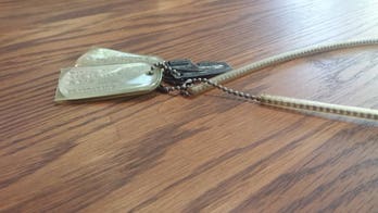 Decades-old dog tags found on Georgia roof; woman searches for owner