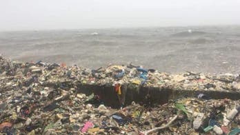 Waves of garbage crash ashore in stunning footage