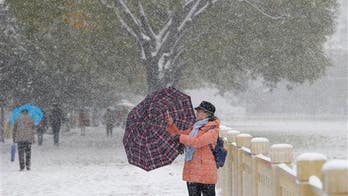 Beijing's snow is so dirty, it advises use of umbrellas