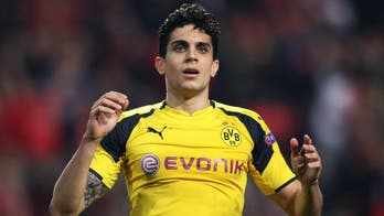 Borussia Dortmund's Marc Bartra injured and sent to hospital after explosions near team bus