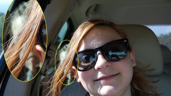 Girl captures chilling image of 'ghost child' in back of her mom's car