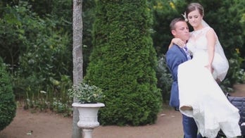 Groom carries wheelchair-bound bride down aisle