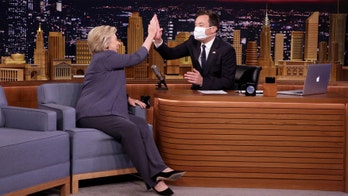 Jimmy Fallon dons surgical mask to greet Hillary Clinton