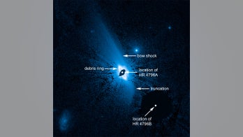 Giant alien planet may lurk inside star's lopsided dust structure