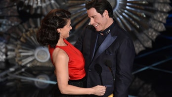 John Travolta and Idina Menzel share Oscars stage
