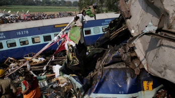 At least 145 killed in India train crash as rescuers scour wreckage for bodies