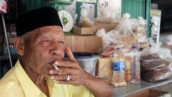 Indonesia begins printing graphic health warnings on cigarette packs