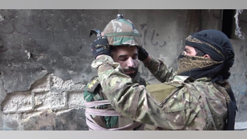 ISIS fanatics turn captured Syrian soldier into missile, attach bomb to his head before tossing him