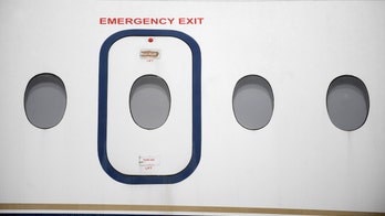 Passengers restrain woman who allegedly tried to open exit door during flight