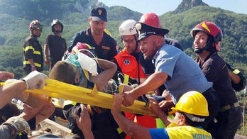 Italian rescue workers rescue three brothers from rubble following earthquake