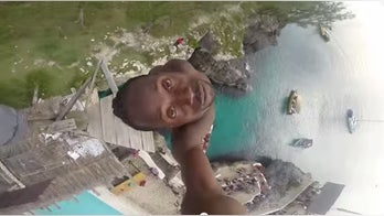 Jamaican man makes extreme dive off 100ft cliff into rocky waters
