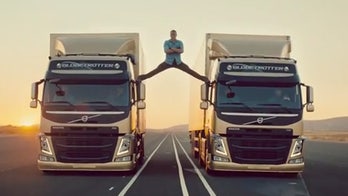 Jean-Claude Van Damme does sky-high split between two trucks