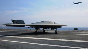 Fighter jets and X-47B drones practice rapid-fire launches