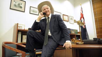 Australian lawmaker won't apologize for ad suggesting he shot his rivals