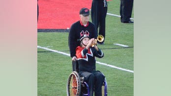 Dad pushes daughter's wheelchair on field to fulfill her marching band wish