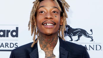 Rapper Wiz Khalifa cuffed for riding hoverboard