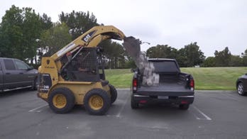 Honda Ridgeline's plastic bed survives landscaping stone challenge