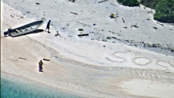 'SOS' message in sand leads to rescue of stranded boaters