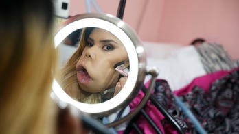 Woman with facial tumor gains fame as makeup vlogger