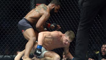 Woodley retains belt in UFC 209