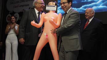 Uproar in Chile after economy minister poses with inflatable doll at dinner party