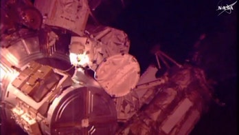 Astronauts help move stalled rail car during spacewalk