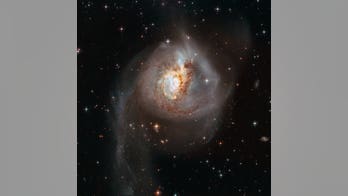 Galaxy distorted by long-ago collision glows in gorgeous Hubble photo