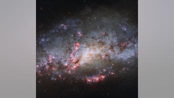 Pink clouds reveal galactic collision in new Cocoon Galaxy image