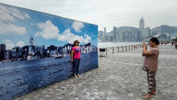 Hong Kong skyline banner provides tourists ideal backdrop, ignores pollution