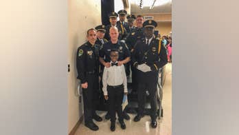 Police officers attend boy's 5th grade graduation in place of fallen father