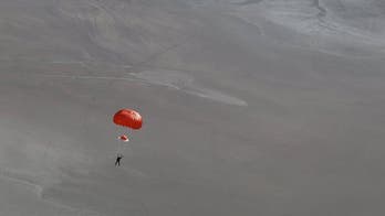 Stunning photo shows SpaceShipTwo pilot parachuting to Earth after crash
