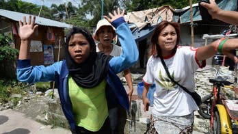 Police battle protesters in Philippines slum riot