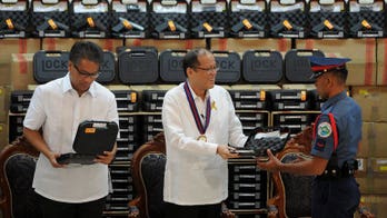 Aquino vows more Philippine police -- with guns -- on beat