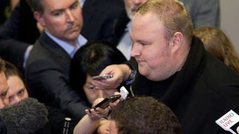 Kim Dotcom and N.Z. PM trade barbs over spy laws
