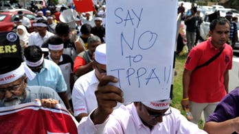 Malaysia detains 14 trade deal protesters