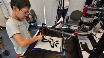 Robot turning Japanese children into calligraphers
