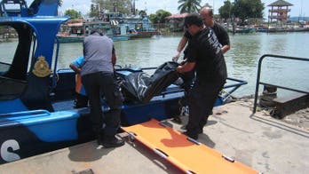 Malaysian rescuers find fourth body; 36 still missing