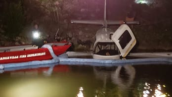 Plane ends up nose-first in Tennessee River after pilot overshoots runway