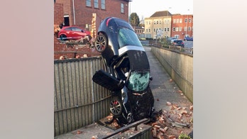 73-year-old survives crash through brick wall and down 10-foot drop