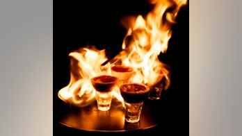 Woman's head set on fire while taking flaming shot