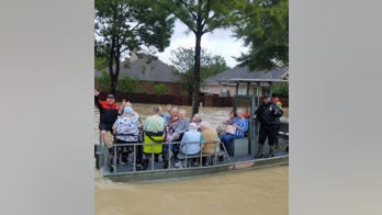 Houston police officer battling cancer braves floodwaters to rescue residents
