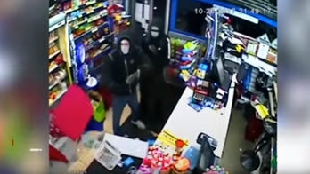 Knife-wielding would-be robbers run after shopkeeper throws things at them