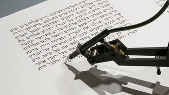 Robot takes on ancient ritual of Torah writing in museum installation
