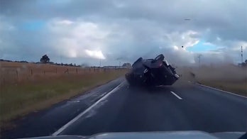 Driver walks away from shocking rollover crash caught on camera