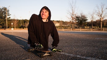 Man born with rare spine condition uses hands, skateboard to get around