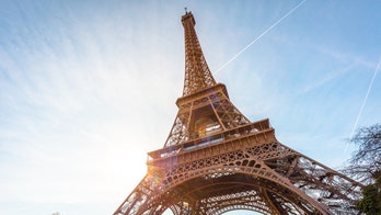 Daredevils zip-line off the Eiffel Tower