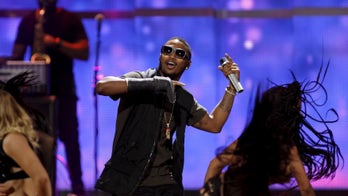 Hip hop star charged with assaulting police officer after allegedly throwing speakers at crowd